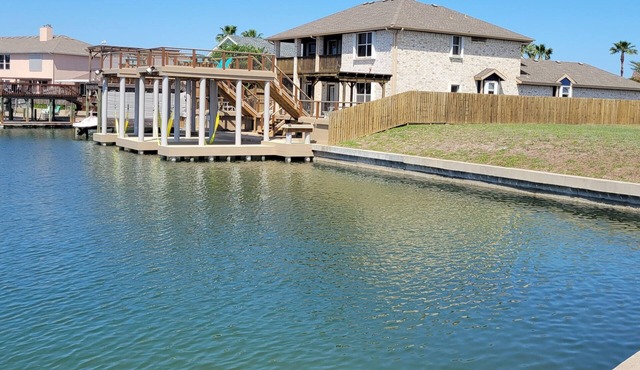 Bottom level canal water front home with spacious deck, boat dock, and parking! in Corpus Christi